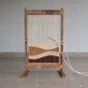 Standing wooden handloom with weaving threads and shuttle for kids creative learning