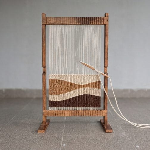 Standing wooden handloom with weaving threads and shuttle for kids creative learning
